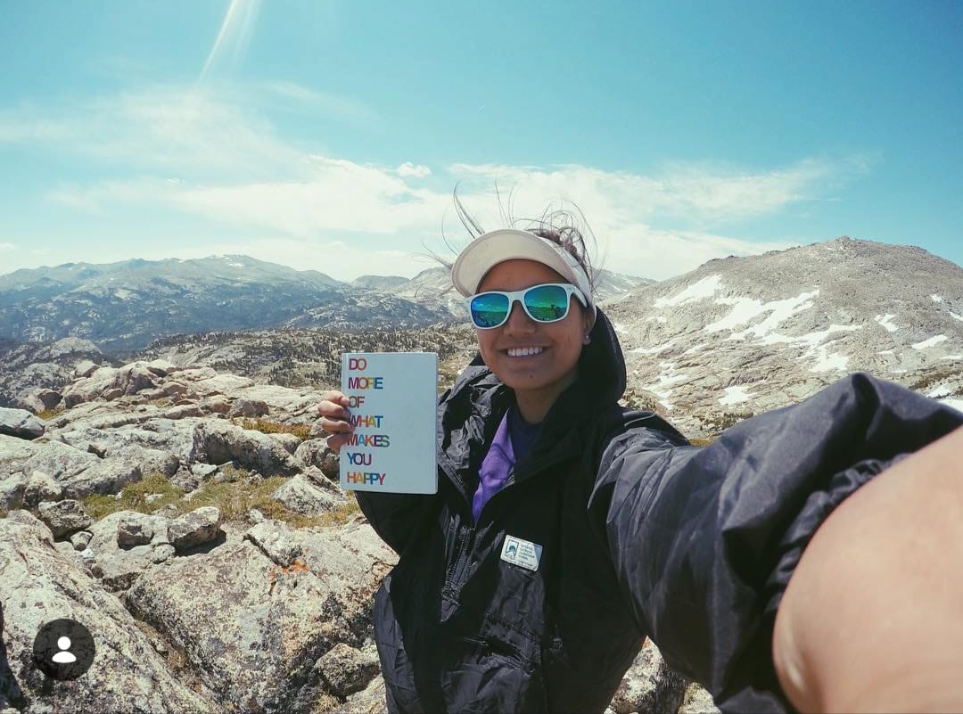 Maria smiling on a mountain adventure