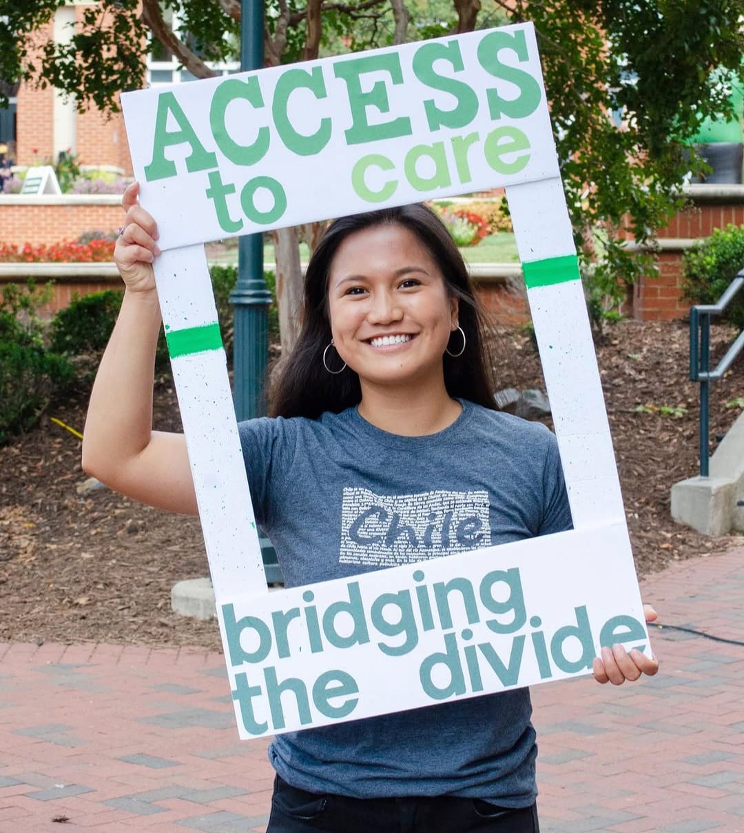 Maria holding an Access to Care frame
