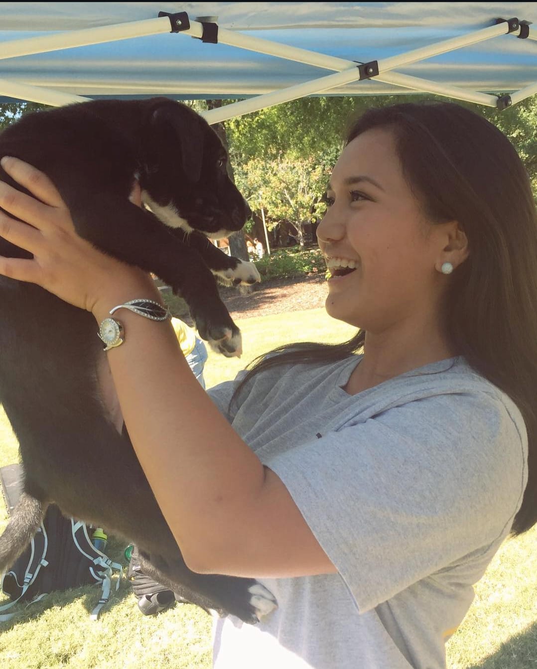 Maria happily holding a puppy