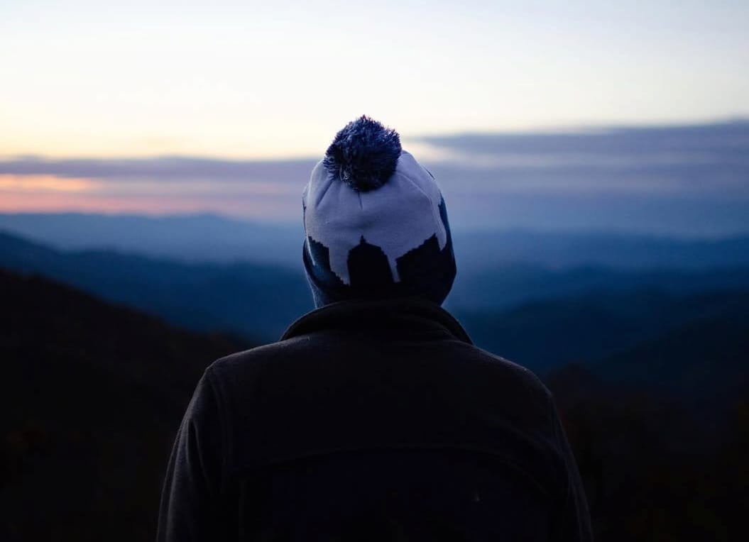 Maria watching the sunrise from a mountain