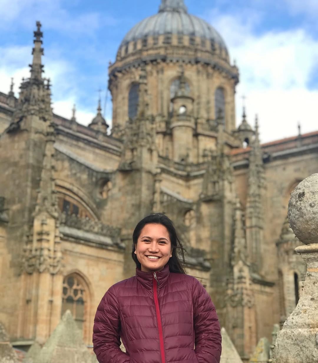 Maria smiling in front of a cathedral